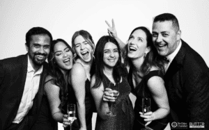 Six people posing together at the gala
